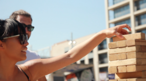 a couple playing jenga at a street festival in Barcelona, Spain