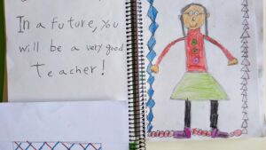 A child's drawing of a smiling woman with text reading 'in the future you will be a very good teacher!'