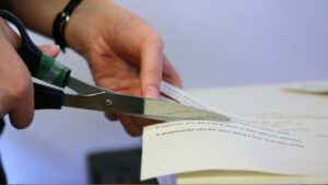 hands cutting with scissors preparing a ESL lesson plan