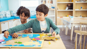 Kid doing a puzzle in a classrooom