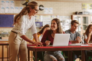 Teacher happy students in computers