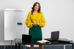 elegant teacher with whiteboard and desk